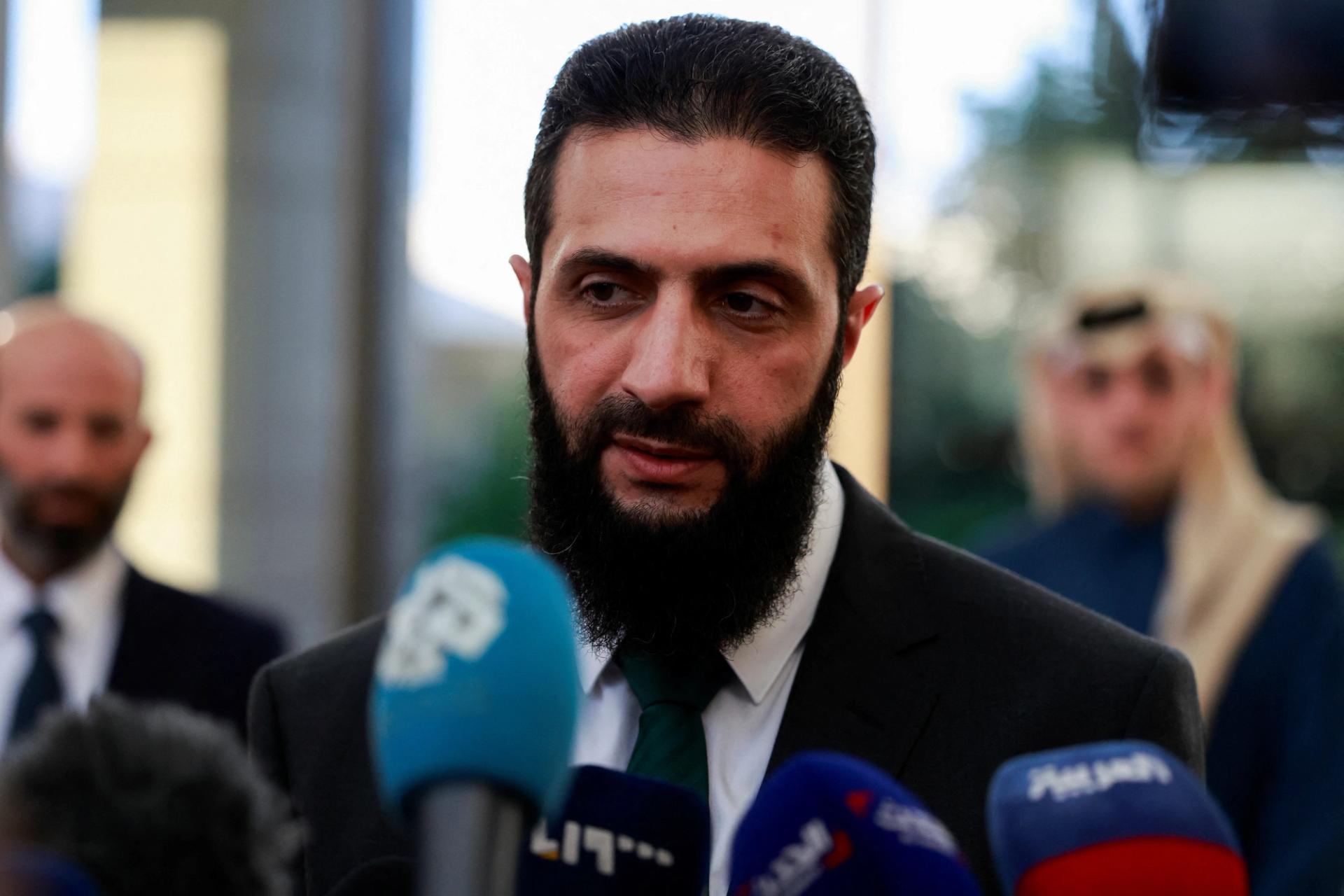 Syria’s de facto leader Ahmed al-Sharaa speaks to the media during a meeting with Qatar’s Minister of State.