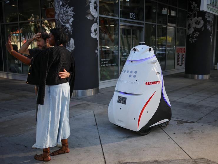A security robot patrols a sidewalk in Downtown Los Angeles