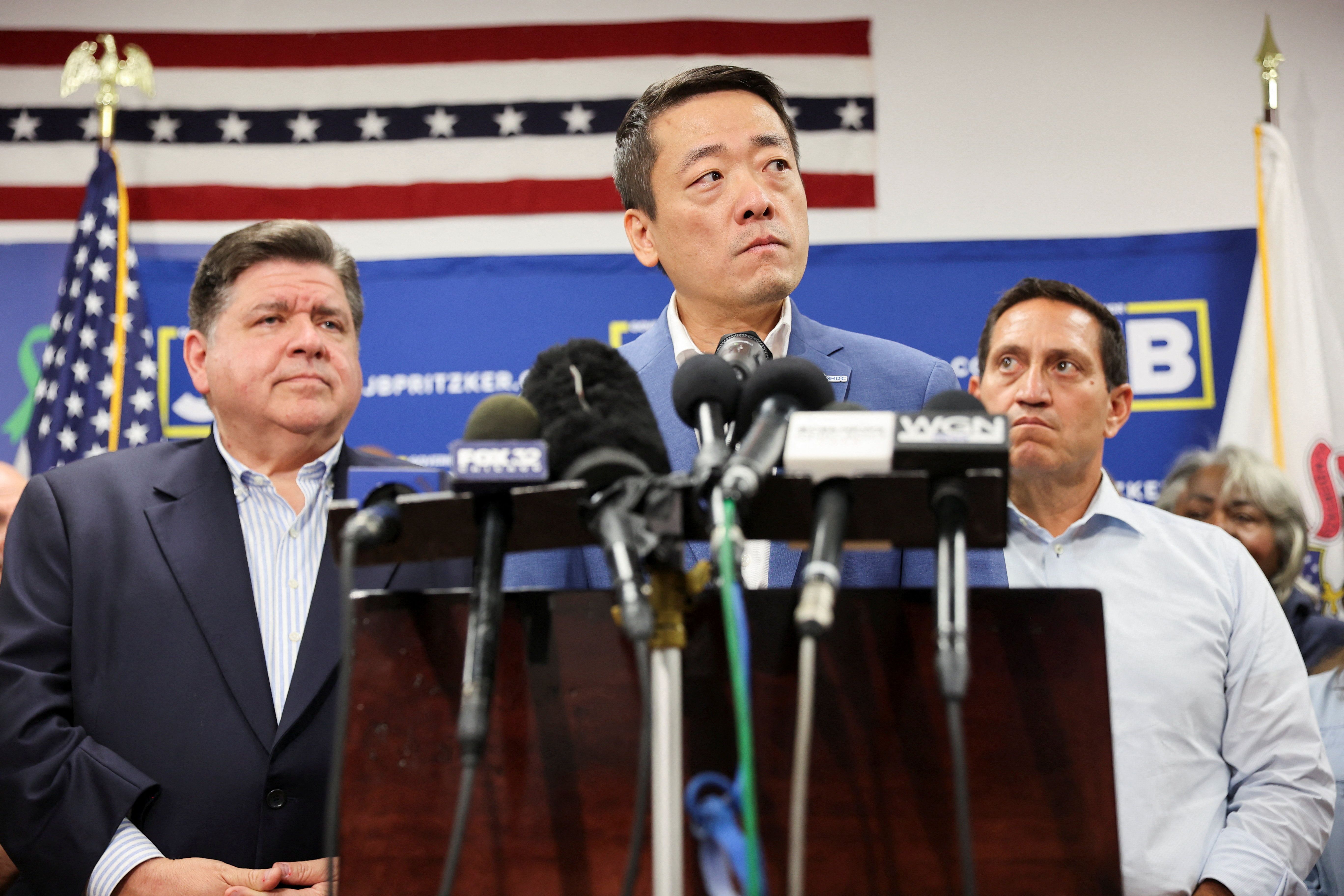 Texas State Rep. Gene Wu looks on, near Texas State Rep. Trey Martinez and Illinois Governor J.B. Pritzker as Democratic lawmakers from Texas hold a press conference.