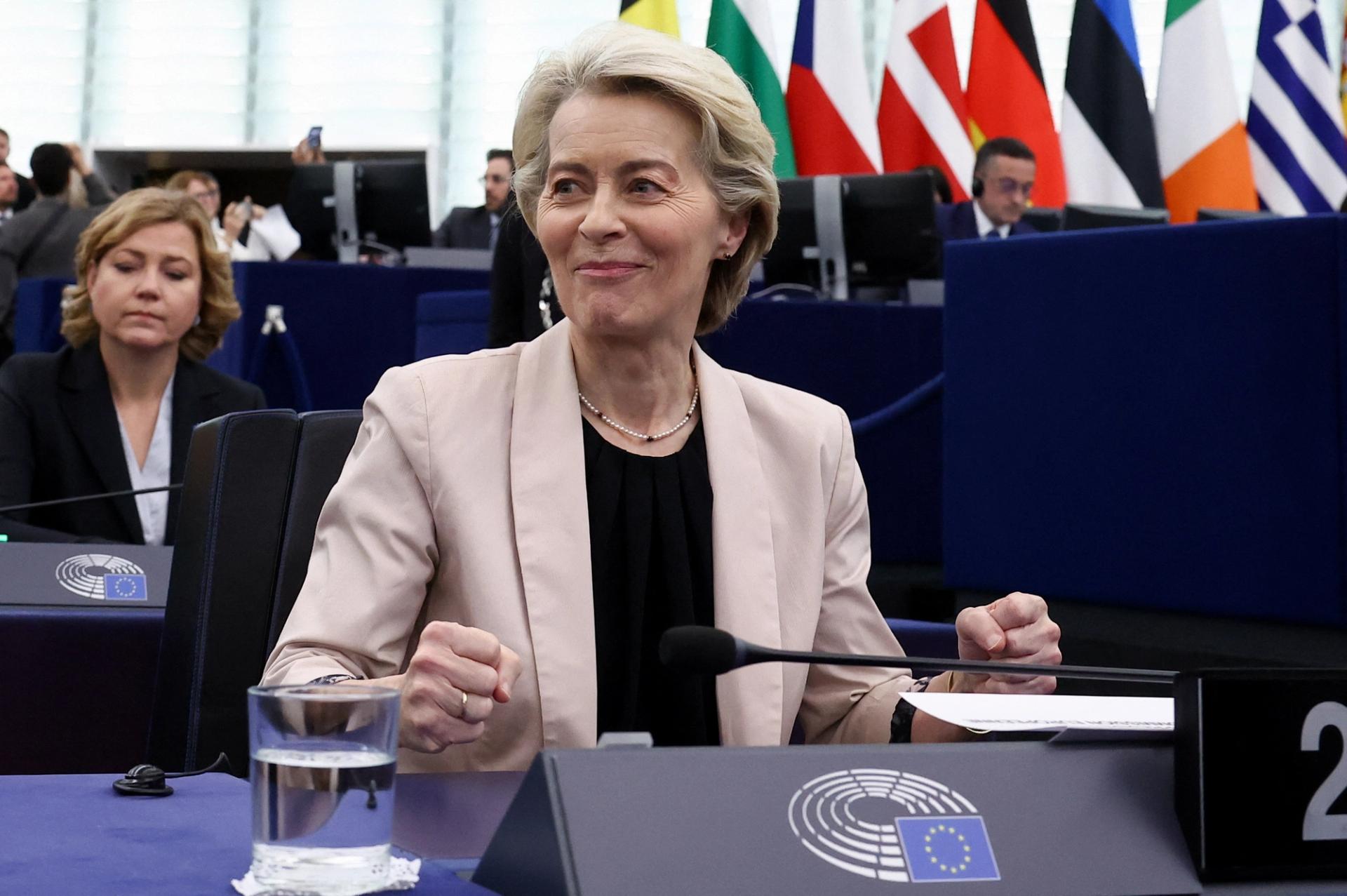 Ursula von der Leyen smiles as she reacts to the European Parliament approving her new Commission