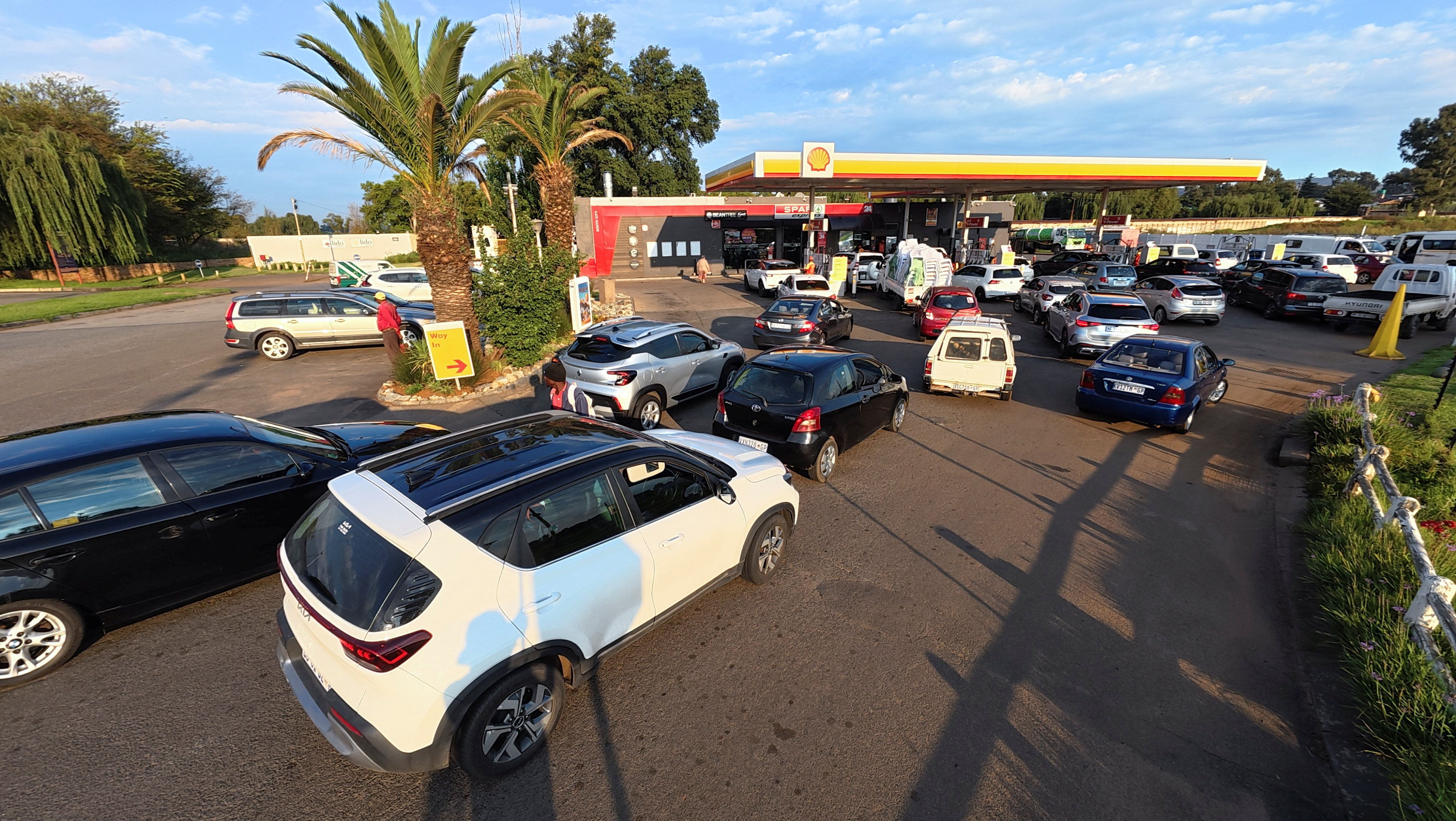 Cars queue at a Shell petrol station after the government announced reducing its fuel levy.