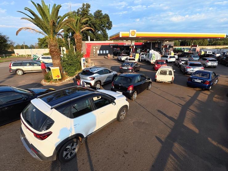 Cars queue at a Shell petrol station after the government announced reducing its fuel levy.