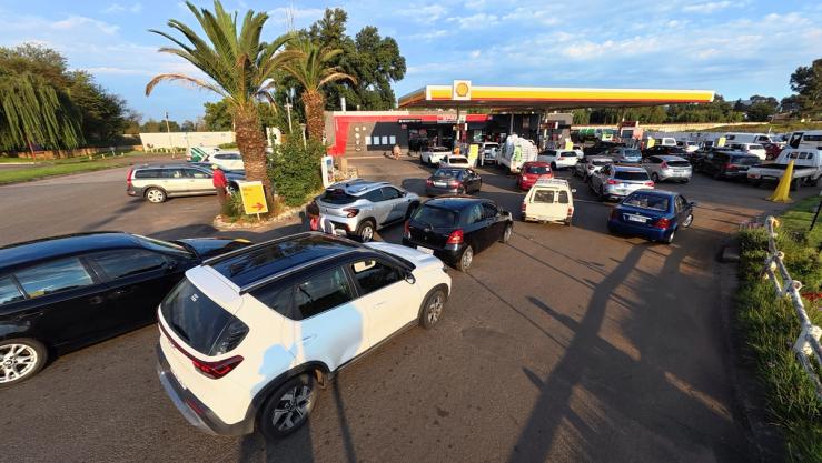 Cars queue at a Shell petrol station after the government announced reducing its fuel levy.