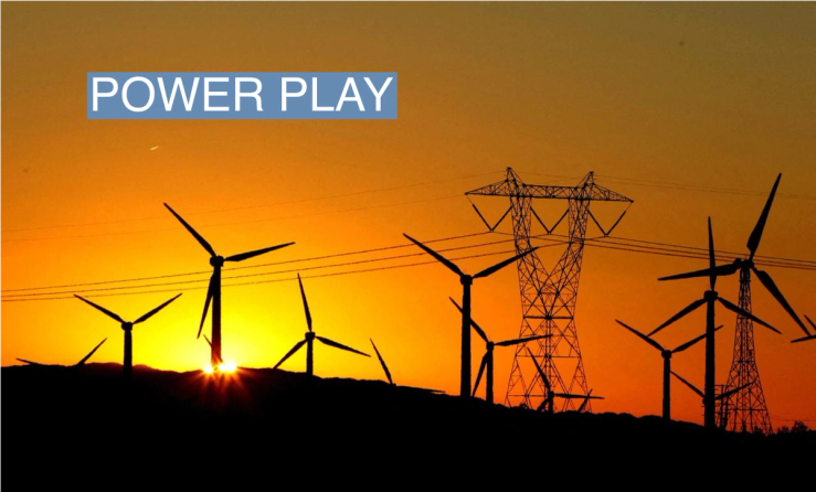 The sun rises behind windmills at a wind farm in Palm Springs, California