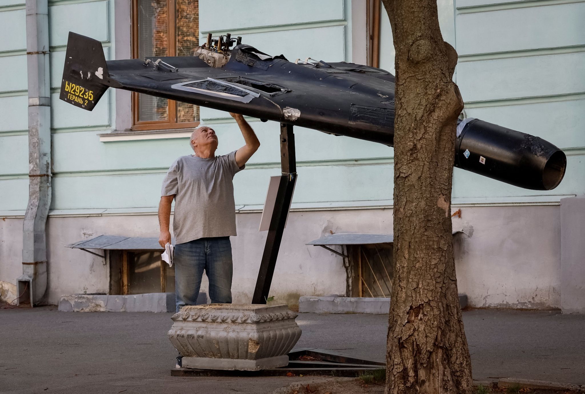 A man looks at a destroyed drone in Kyiv