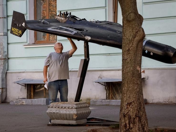 A man looks at a destroyed drone in Kyiv