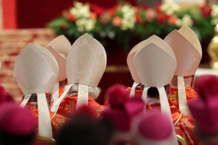 Members of the clergy gather in Rome’s St. Peter basilica.