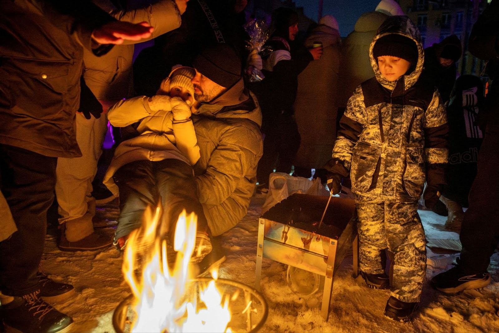 Families in Kyiv around a fire. 
