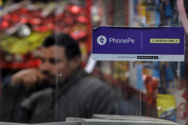 Photo of a PhonePe sticker on the glass of a grocery shop in India
