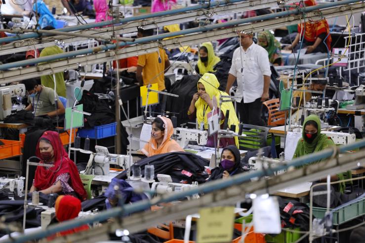 Bangladeshi garment workers make clothing in the sewing section of a factory in Gazipur, Bangladesh.
