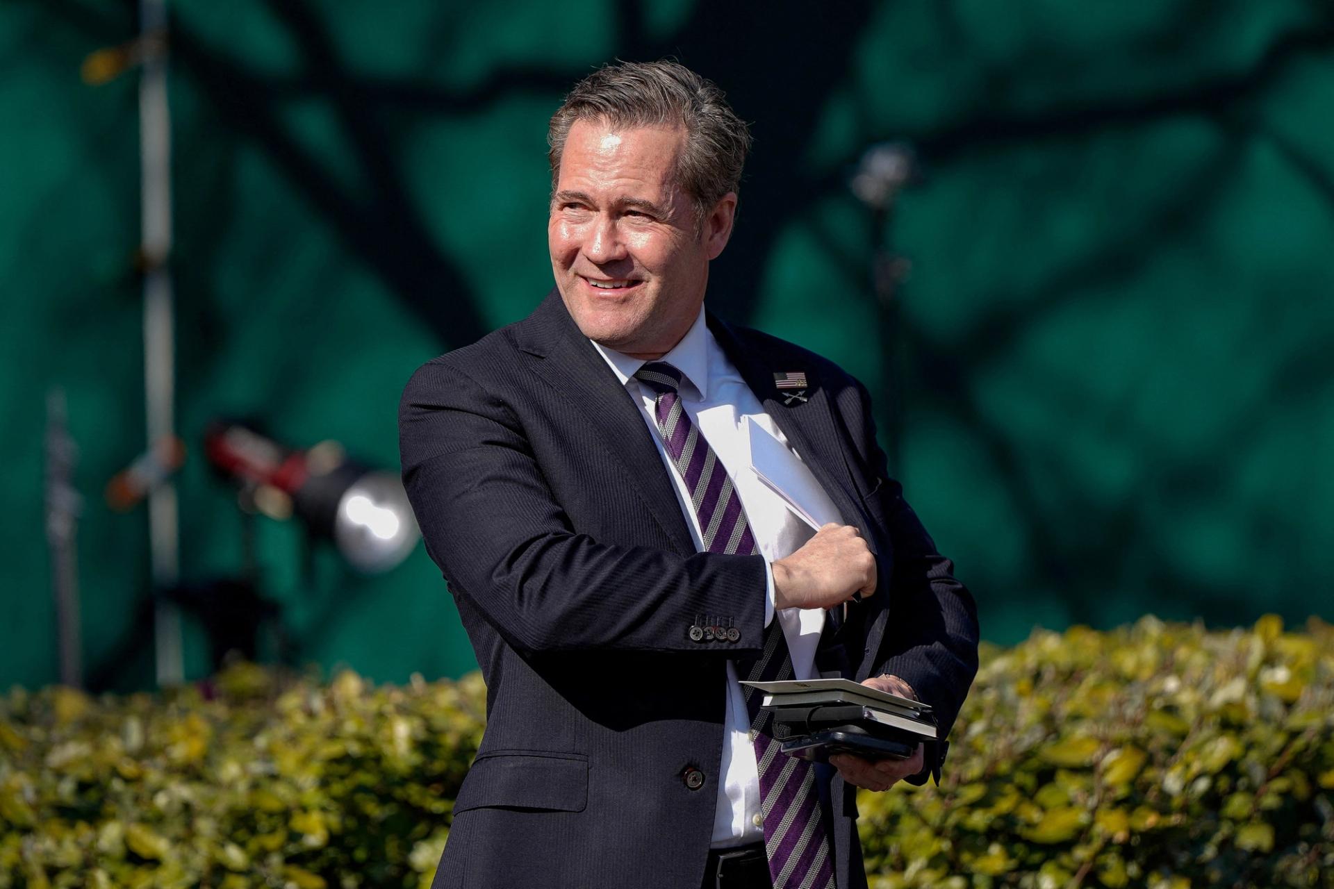 US National Security Advisor Michael Waltz walks towards reporters outside the White House in Washington.