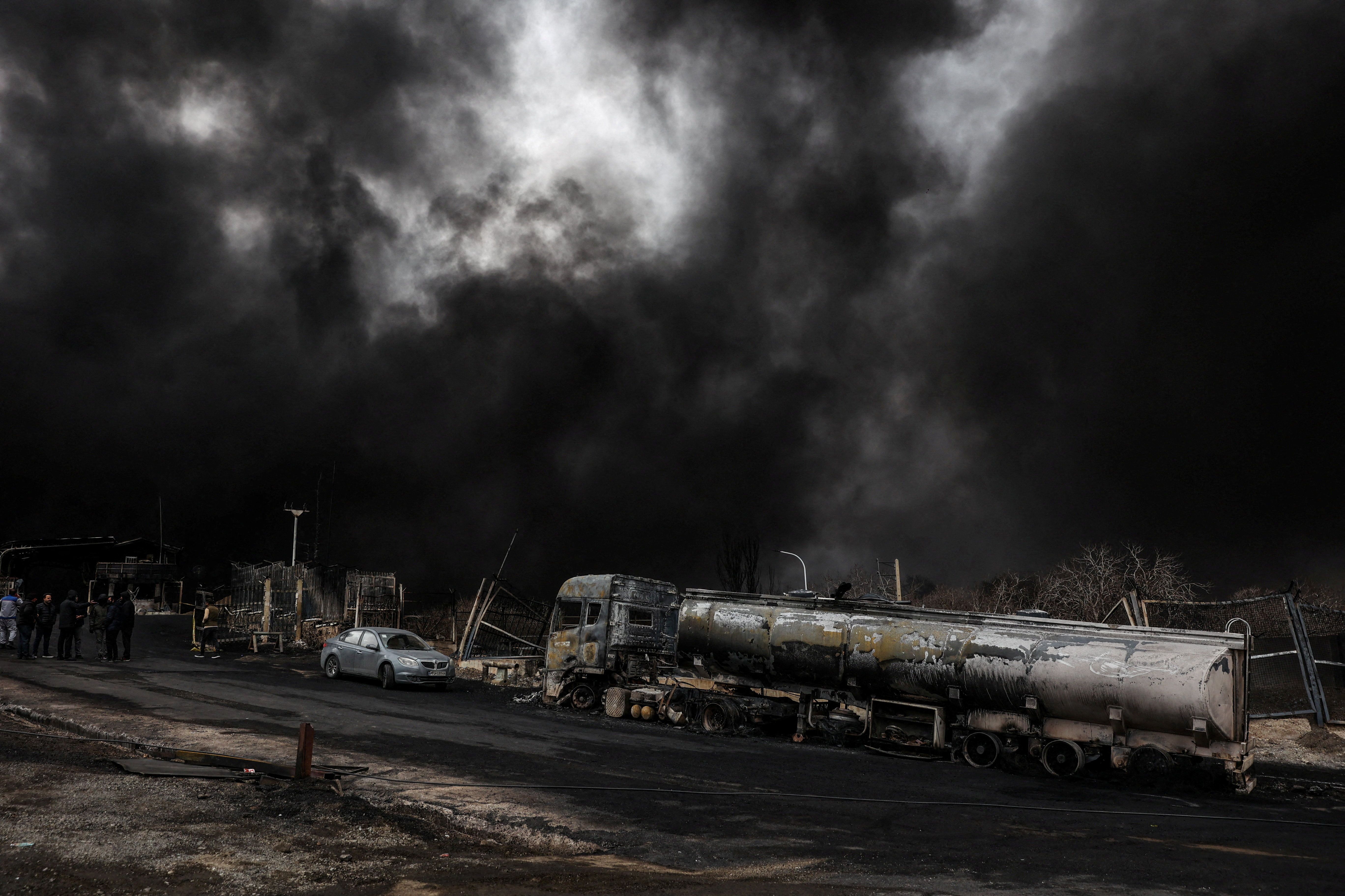Smoke rises after a strike on fuel tank trucks in Iran 