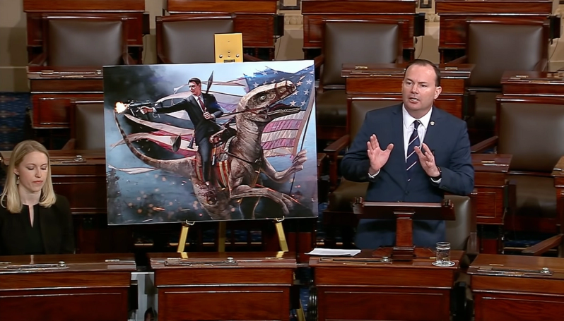 Sen. Mike Lee displays Jason Heuser’s image of Ronald Reagan on a dinosaur on the floor of the Senate.