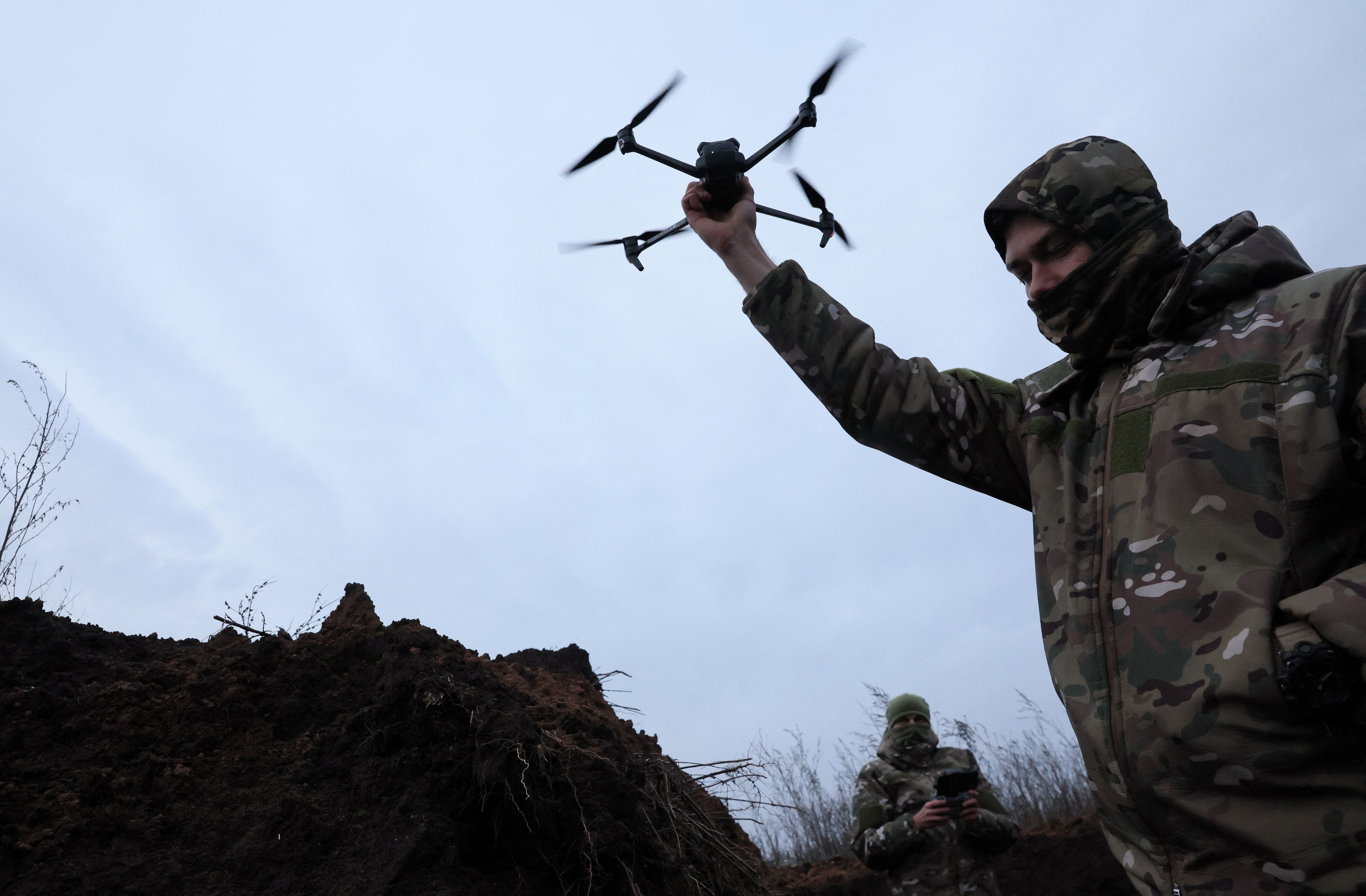 Ukrainian soldier holds a drone