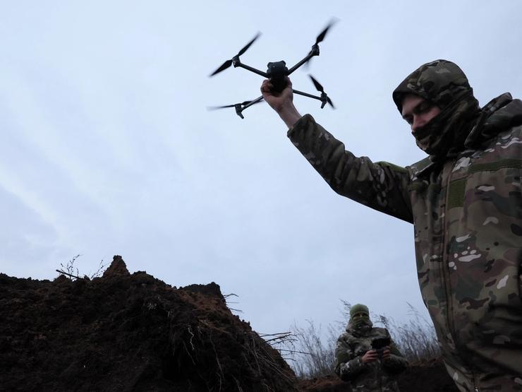 Ukrainian soldier holds a drone