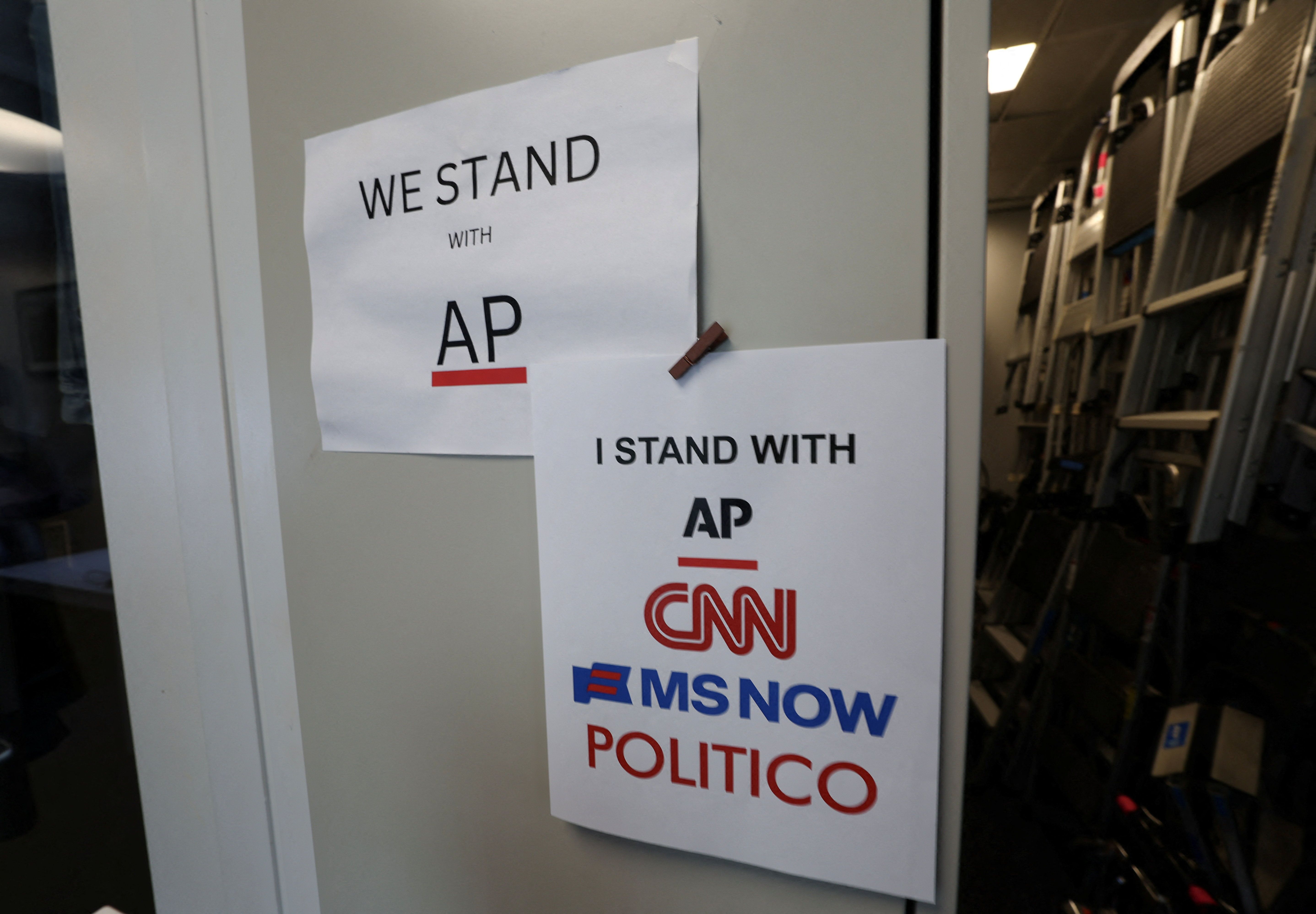 An updated solidarity sign adding CNN, MSNOW and POLITICO hangs outside the Associated Press booth at the White House grounds