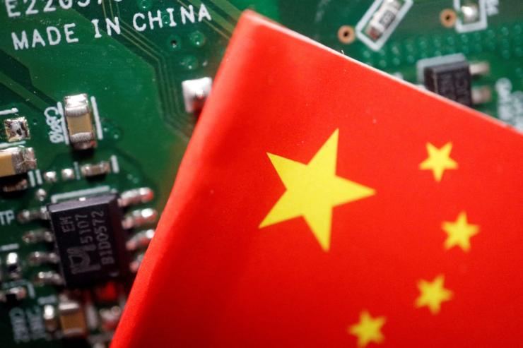 A Chinese flag seen on a printed circuit board with semiconductor chips