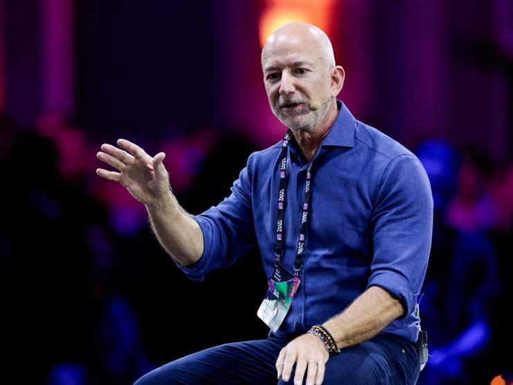 Amazon founder Jeff Bezos gestures as he speaks at the main panel of Italian Tech Week 2025 in Turin, Italy.