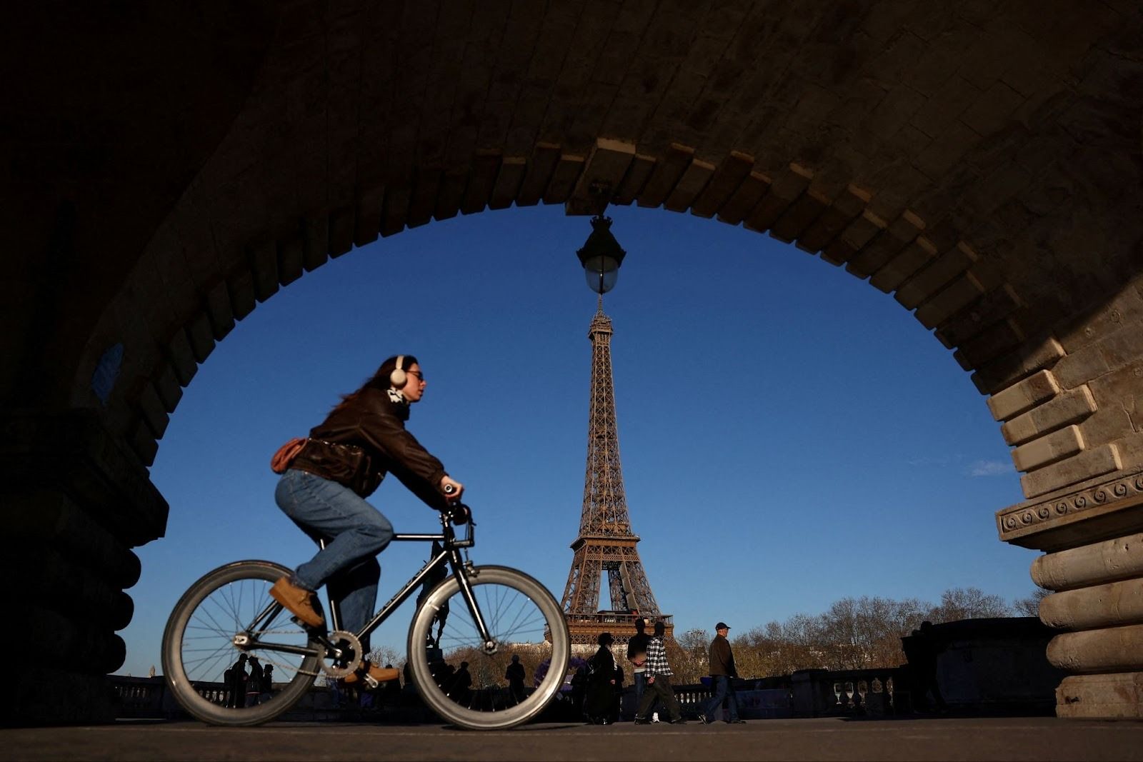 A person riding a bicycle in Paris. 