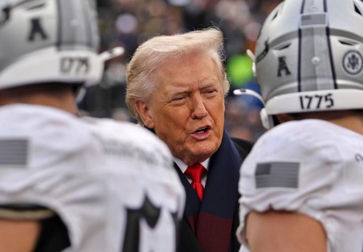 Trump speaks to football players