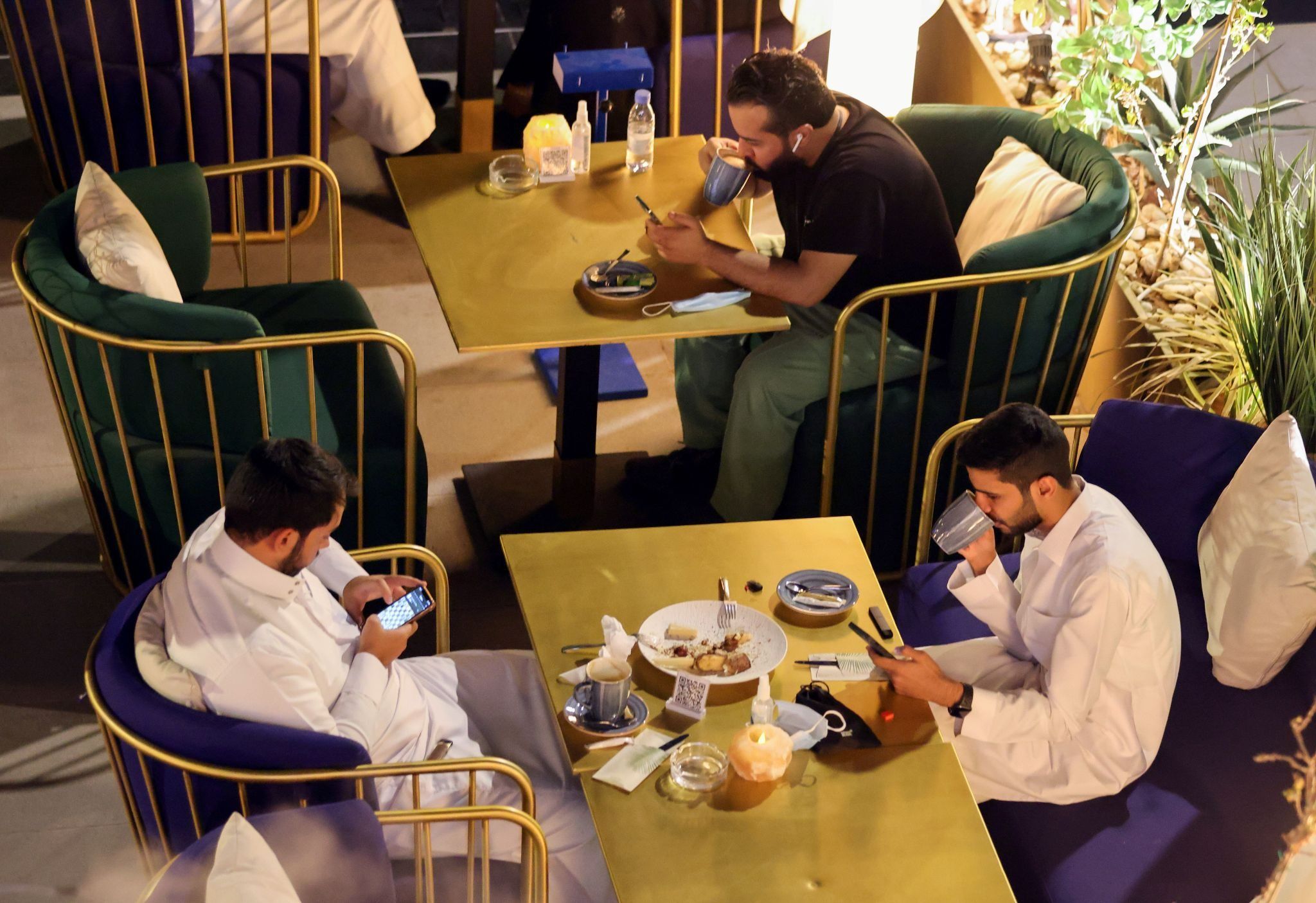 People sit at David Burke’s restaurant, in The Zone restaurant complex, in Riyadh