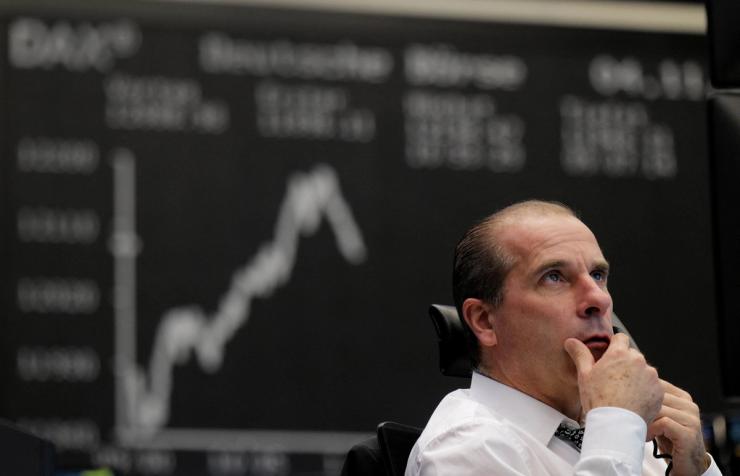 A stock trader looks at his monitors as the German share price index DAX reacts to the U.S. 2020 presidential election at the stock exchange in Frankfurt, Germany.