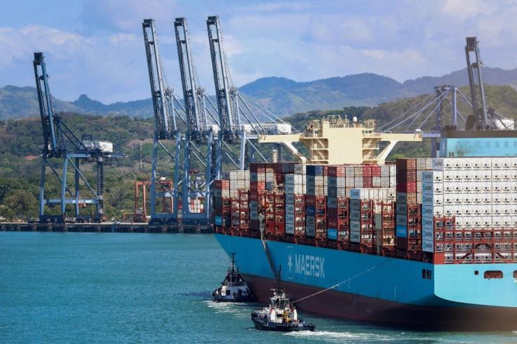 A shipping vessel arriving at a port along the Panama Canal.