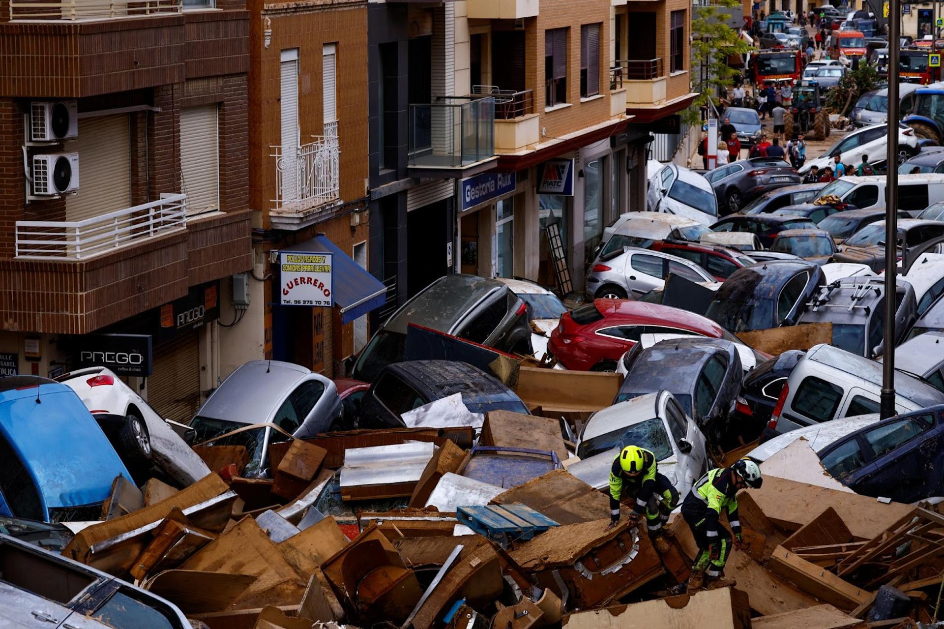 Cars are piled together in Valencia in the aftermath of flooding