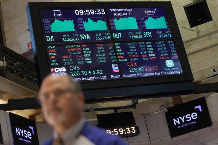 A screen displays market information on the trading floor at the New York Stock Exchange.