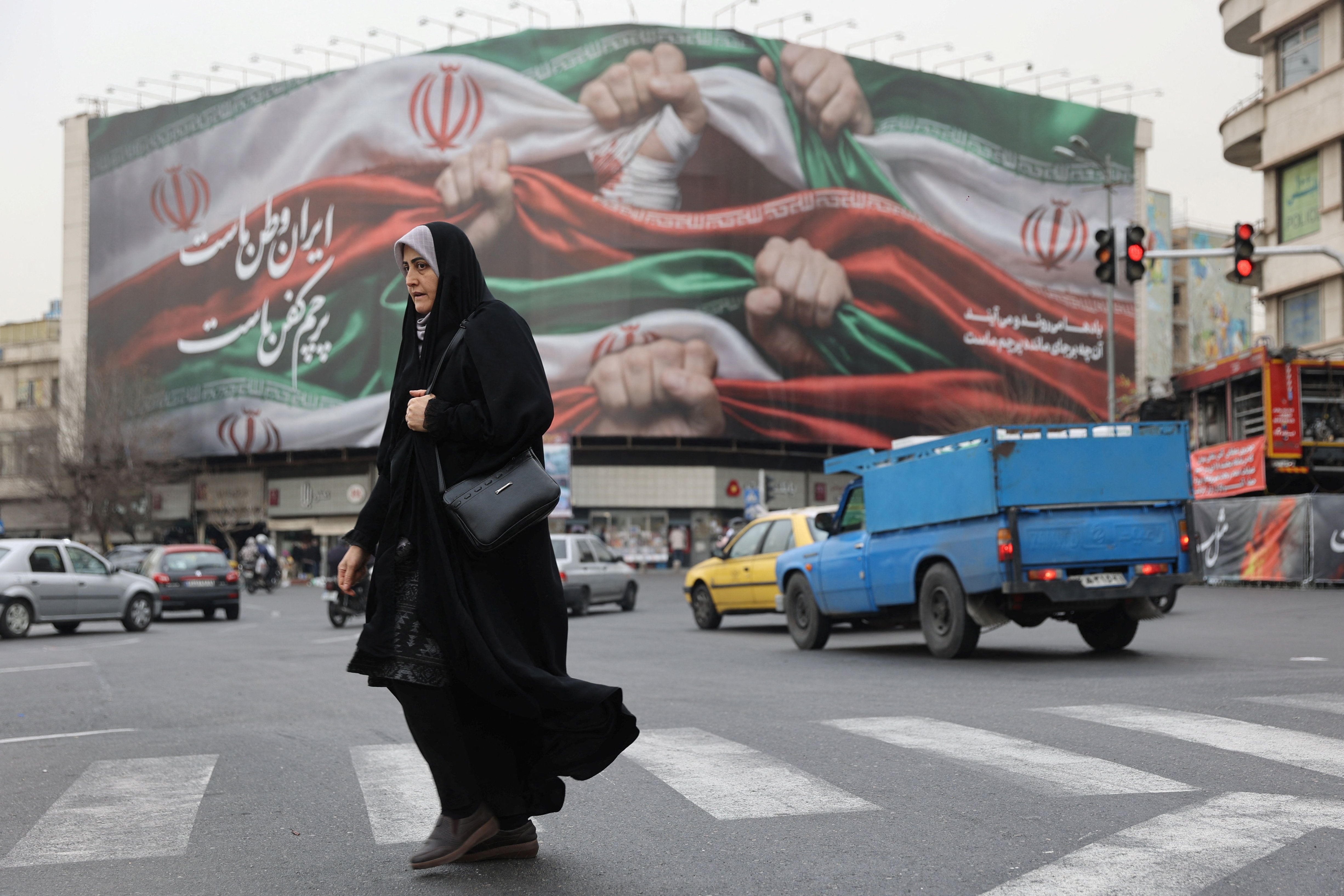 An Iranian woman walks on a street in Tehran, Iran.