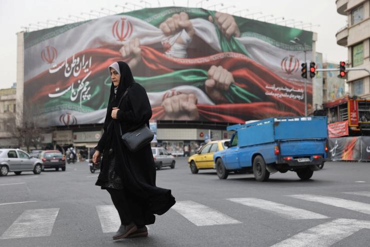 An Iranian woman walks on a street in Tehran, Iran.