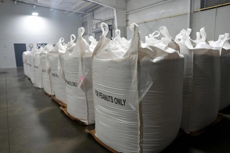 White sacks filled with peanuts.