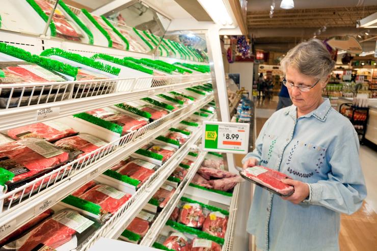 A shopper looks at meat.