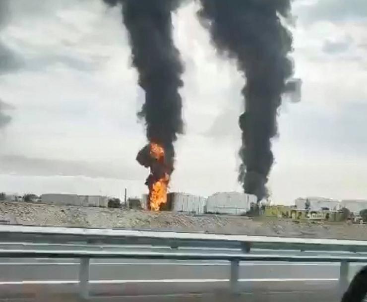 Footage taken from a moving vehicle shows a fire at an oil depot in Feodosia, Crimea, on the day the Ukrainian military said the energy facility was targeted.