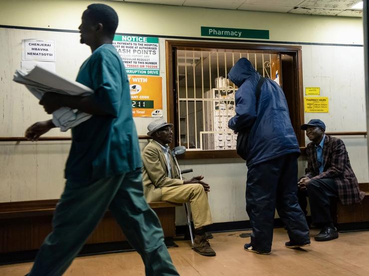 Elderly men wait for medicines at a pharmacy at Parirenyatwa hospital in Harare.