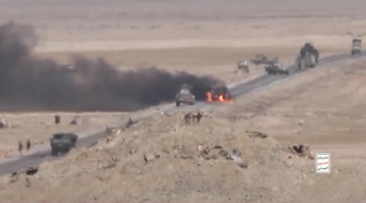 Black smoke billows from a vehicle hit near Dhubab, Yemen.