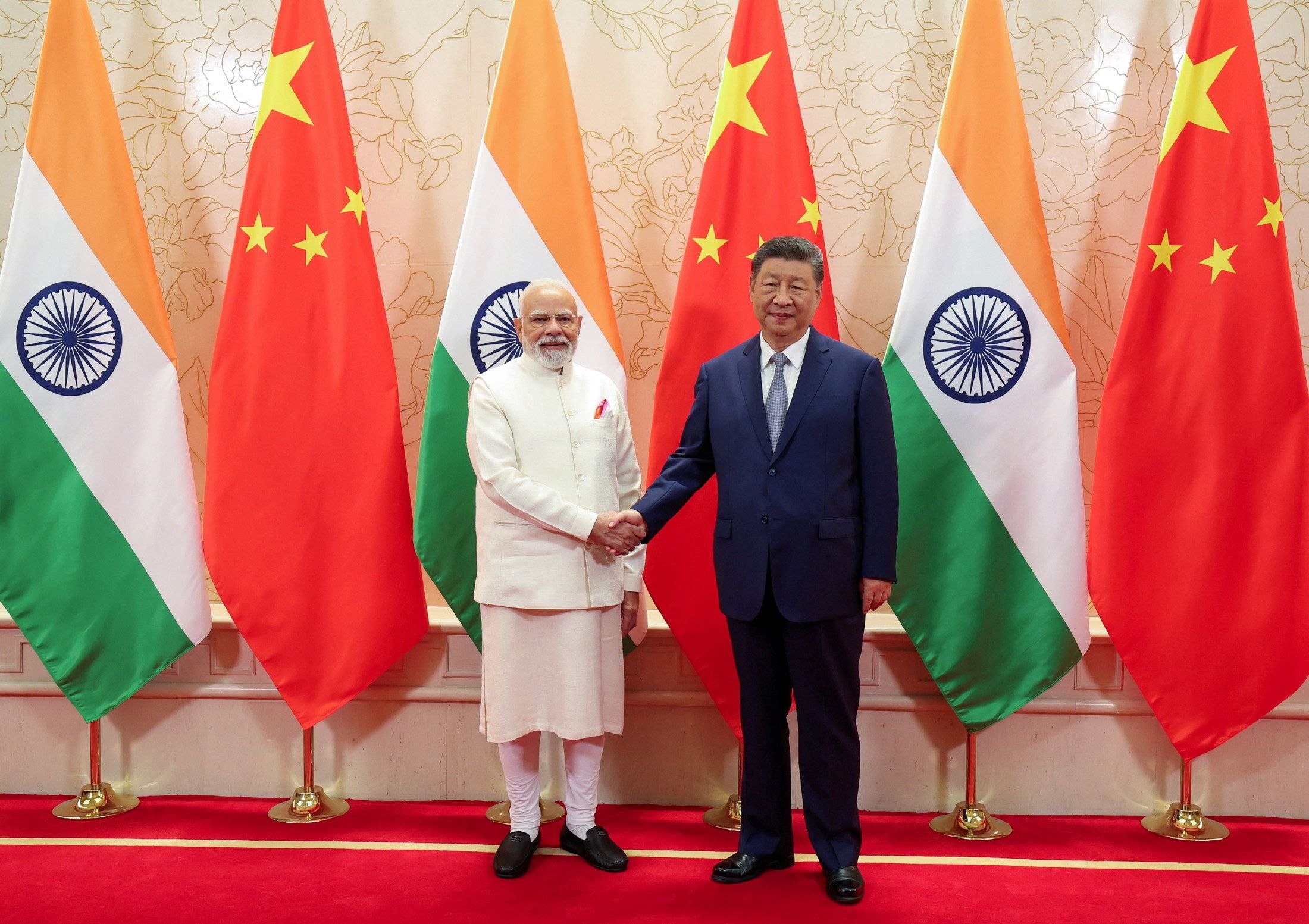 India’s Prime Minister Narendra Modi shakes hands with Chinese President Xi Jinping.