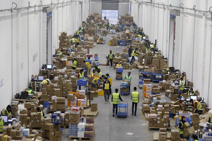 Employees sort boxes and parcels at the logistics centre of a express delivery company, after the Singles Day online shopping festival.