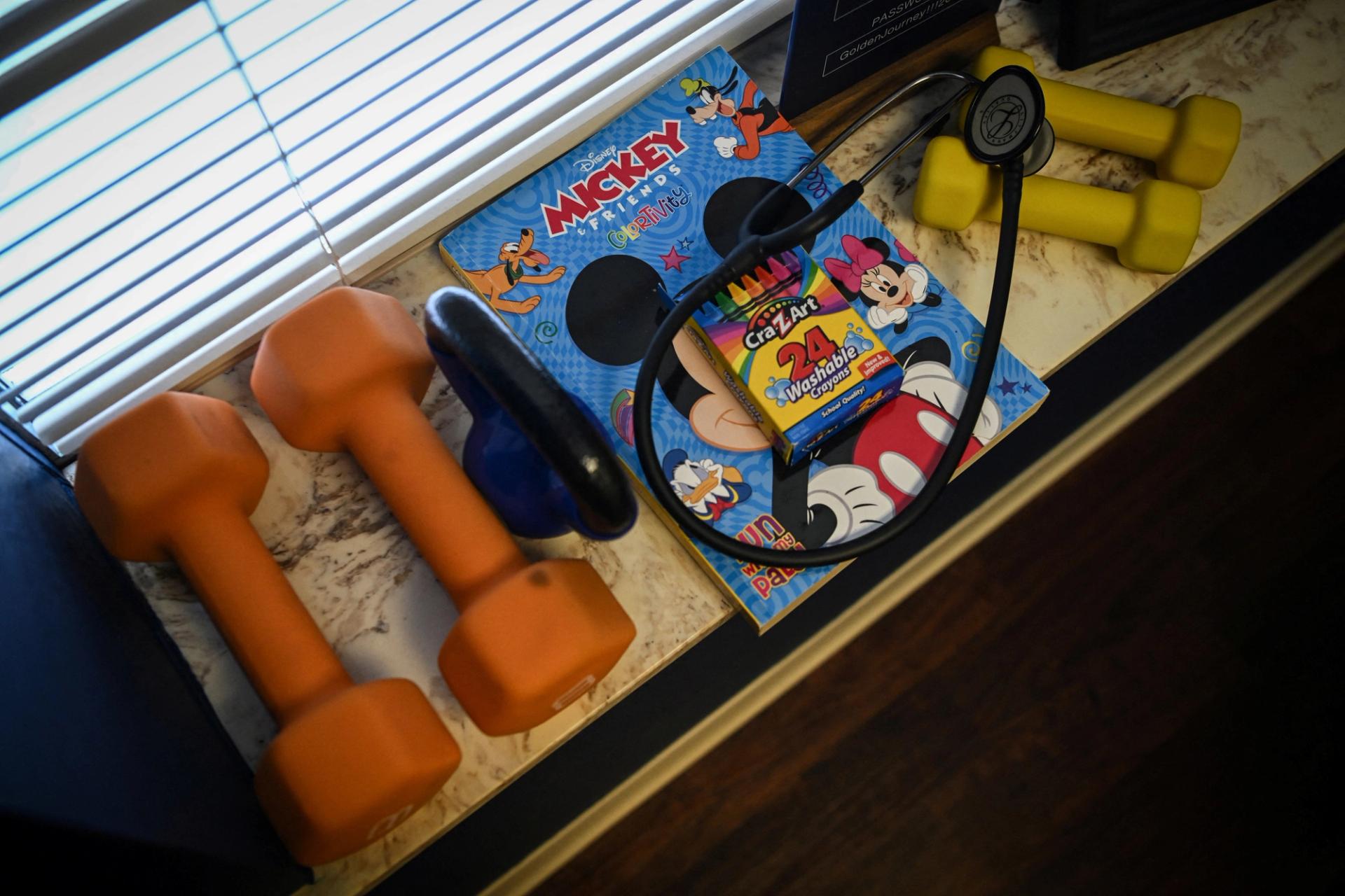 Hand weights and coloring books for patients sit on a shelf at a US clinic.