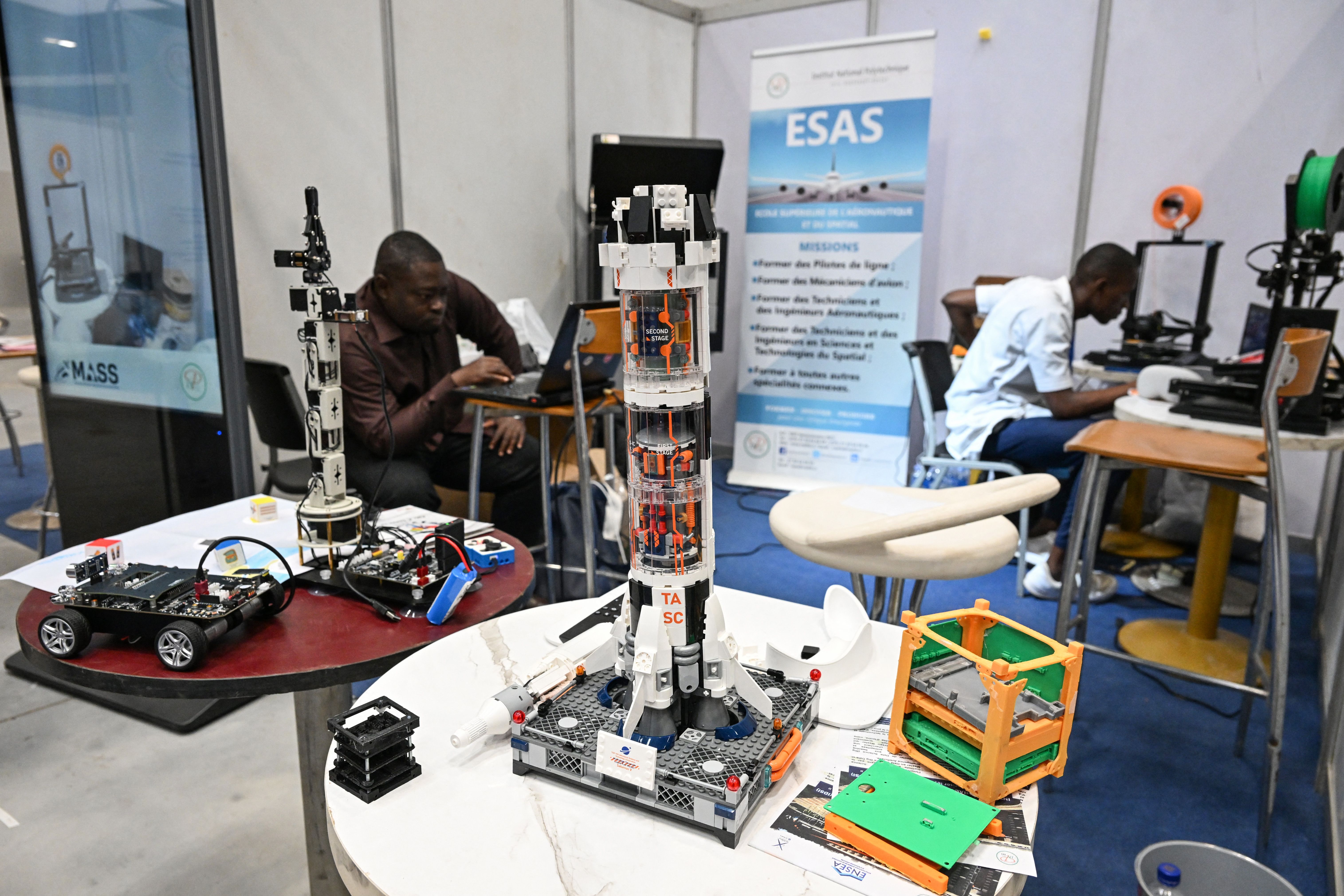 Inventors present a rocket in miniature during the first edition of the African Space Solutions Market (MASS) at the Parc des expositions in Abidjan.