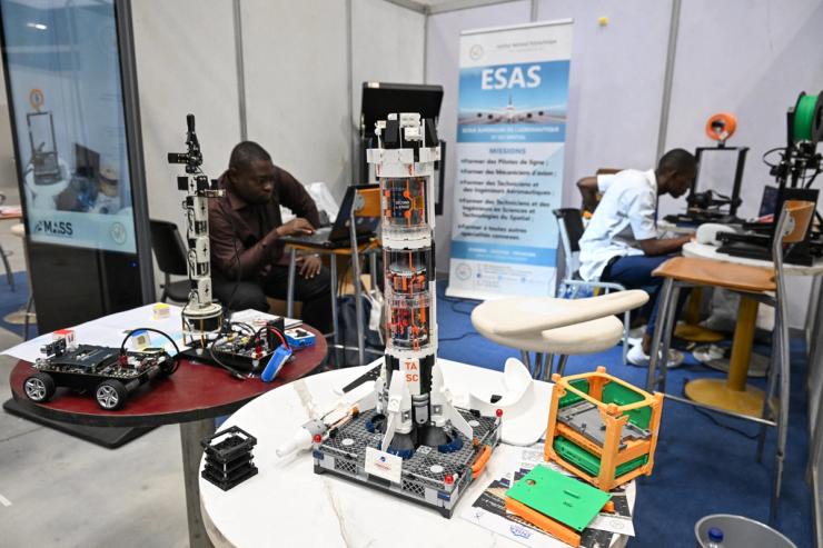 Inventors present a rocket in miniature during the first edition of the African Space Solutions Market (MASS) at the Parc des expositions in Abidjan.