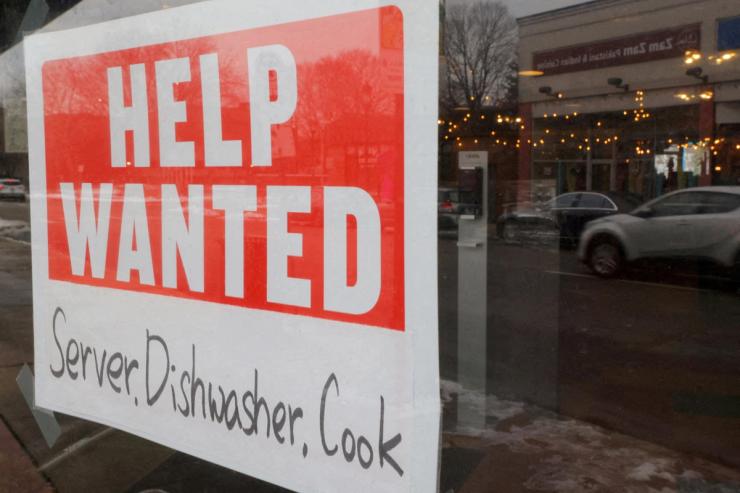 A “Help Wanted” sign hangs in restaurant window in Medford.
