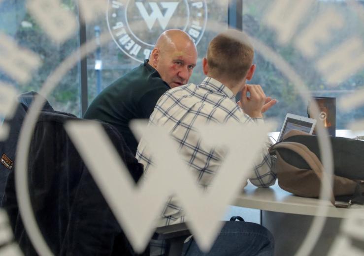 Men speak inside PMC Wagner Centre, which is a project implemented by the businessman and founder of the Wagner private military group Yevgeny Prigozhin, during the official opening of the office block in Saint Petersburg, Russia, November 4, 2022. REUTERS/Igor Russak/File Photo