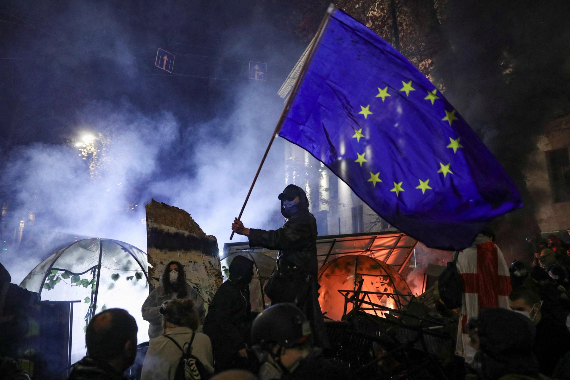 A demonstrator waves a European Union flag during a protest.