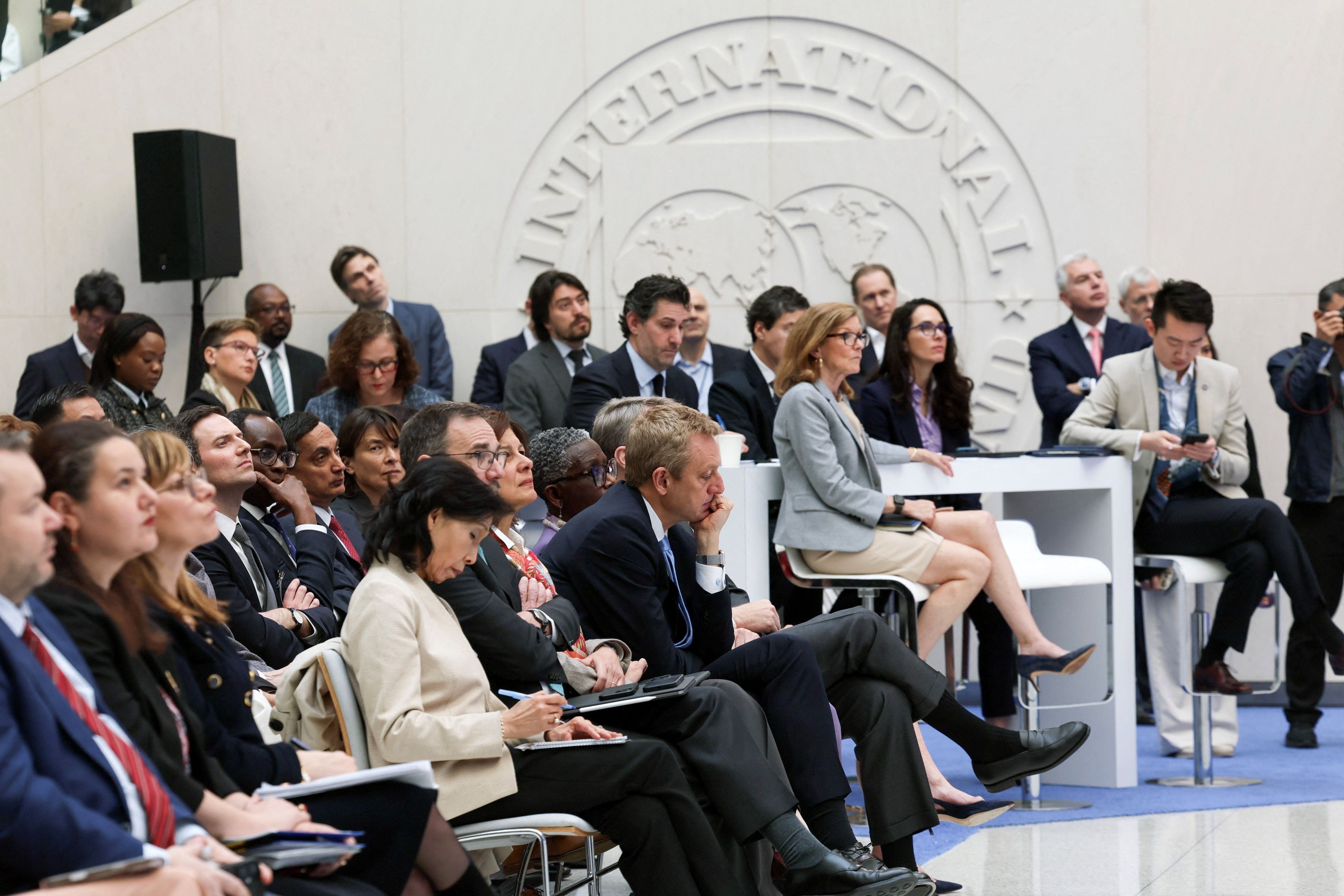 People listen to International Monetary Fund (IMF) Managing Director Kristalina Georgieva (not pictured) deliver remarks on the global economy, ahead of the IMF/World Bank Spring Meetings in April 2025.