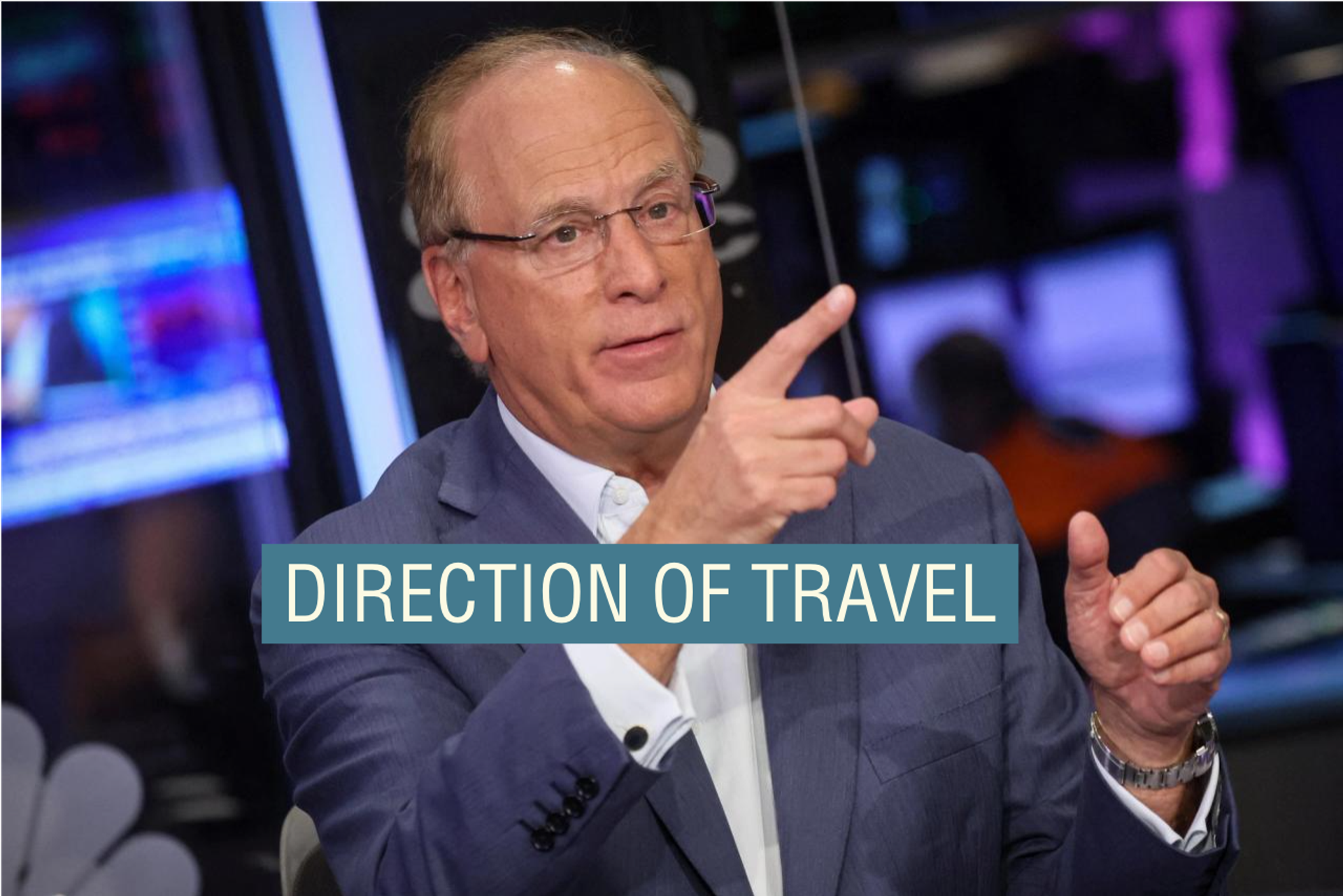 Larry Fink, wearing a light blazer and white shirt, appears to point upwards