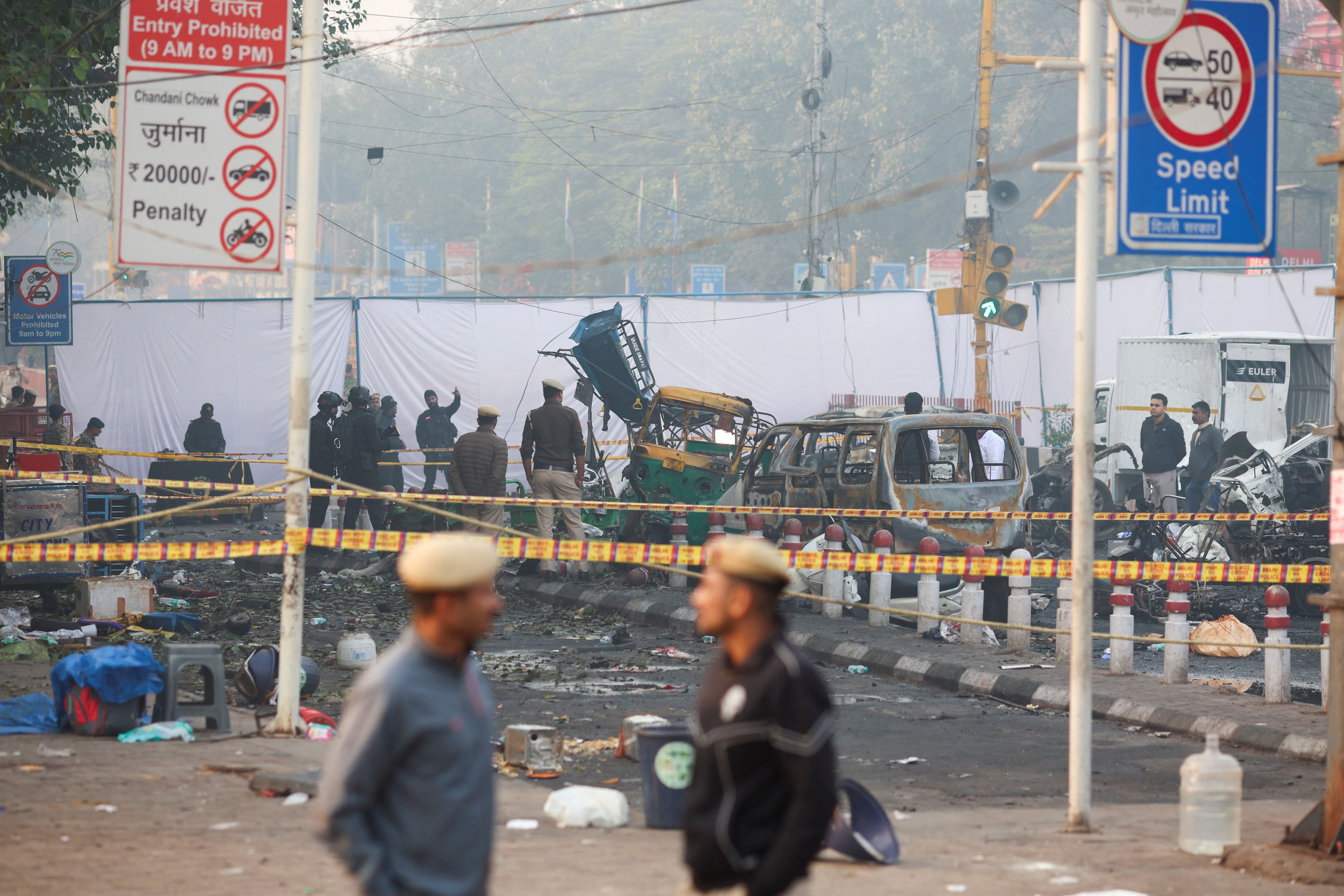 Security personnel and members of the forensic team work at the site of an explosion near the historic Red Fort in the old quarters of Delhi