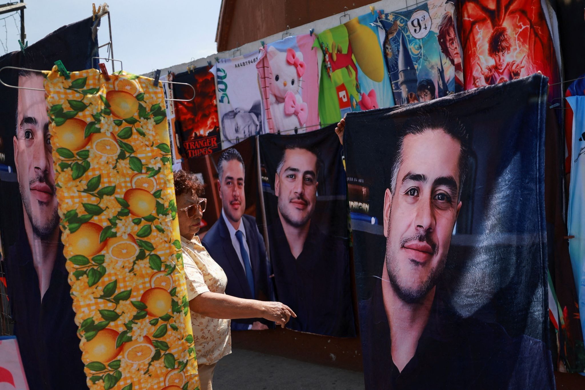 A street vendor sells Omar Garcia Harfuch merchandise