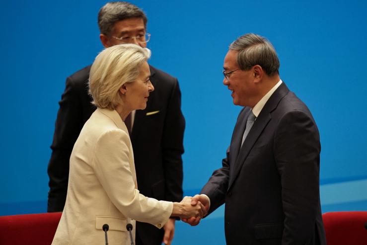 Chinese Premier Li Qiang shakes hands with President of the European Commission, Ursula von der Leyen.
