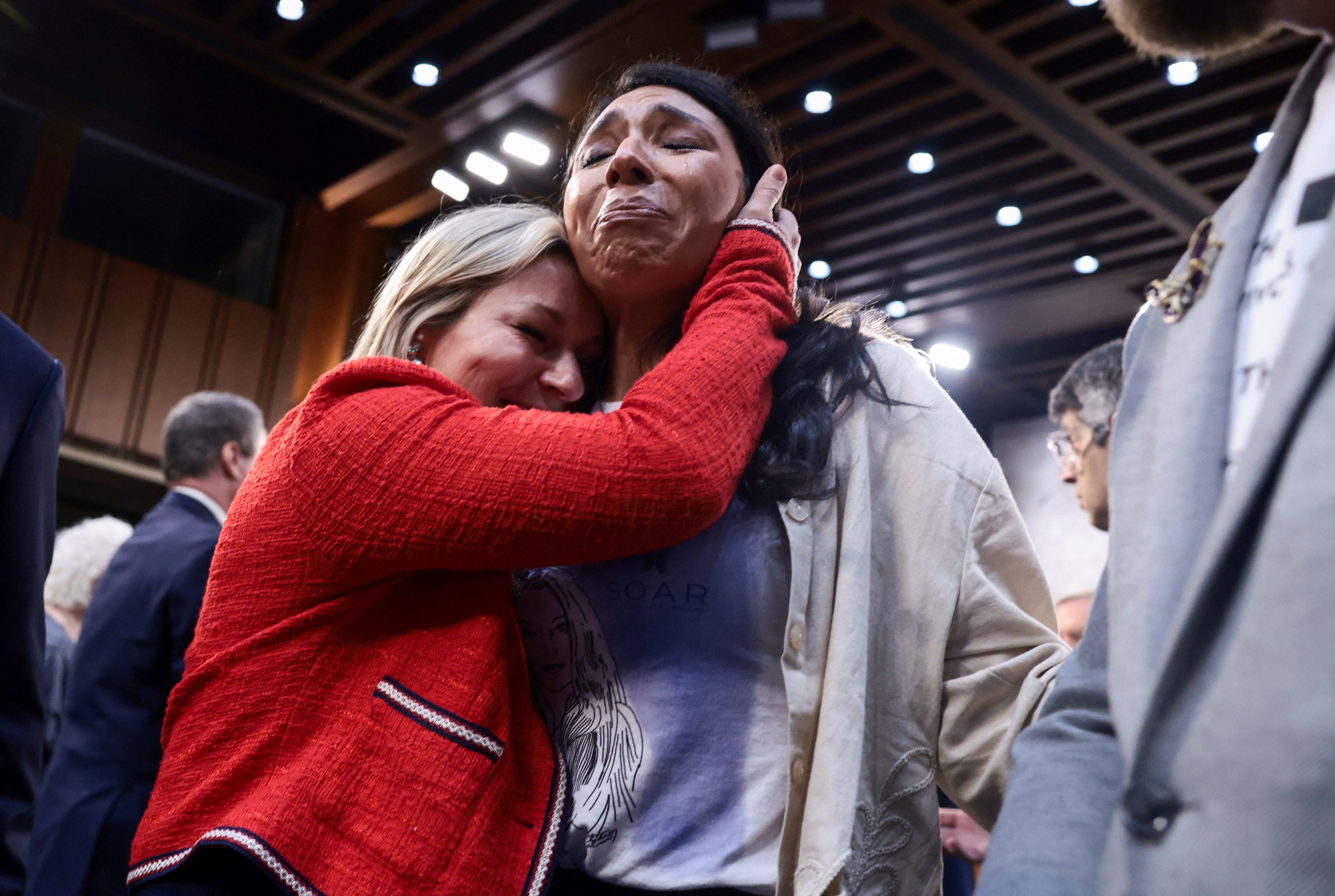 Danielle Bensky, a survivor of the late convicted sex offender Jeffrey Epstein hugs Amanda Roberts, sister-in-law of Virginia Giuffre, victim of late financier and sex offender Jeffrey Epstein
